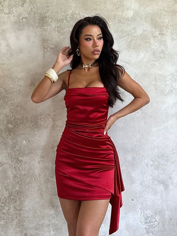 A sophisticated and high-end little red dress—perfect for grand occasions—featuring a strapless satin bodice with spaghetti straps; a chic Western-style party dress or cocktail mini-dress.