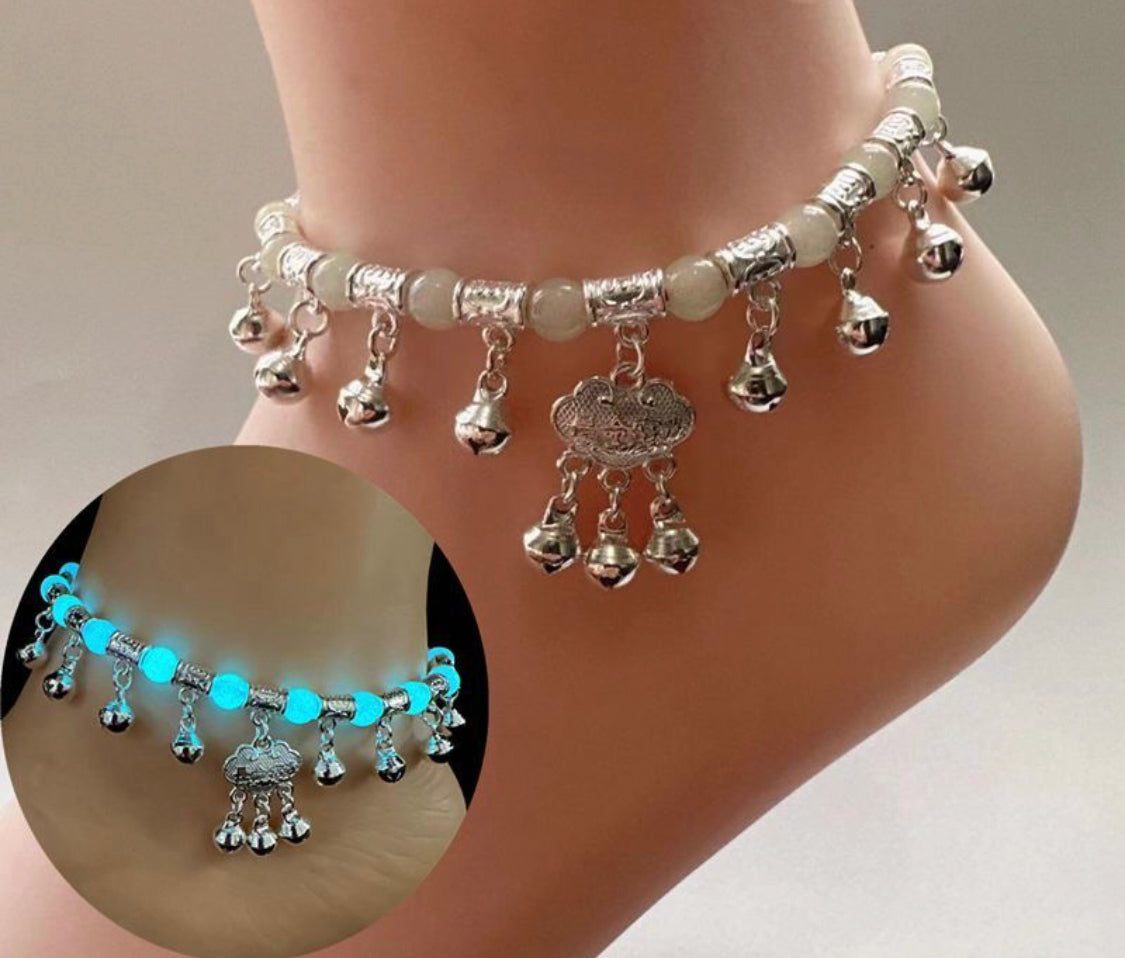 Women's vintage ethnic-style anklet featuring a red braided cord, a "Longevity Lock" charm, and Tibetan silver bells that jingle, accented with a glow-in-the-dark stone.