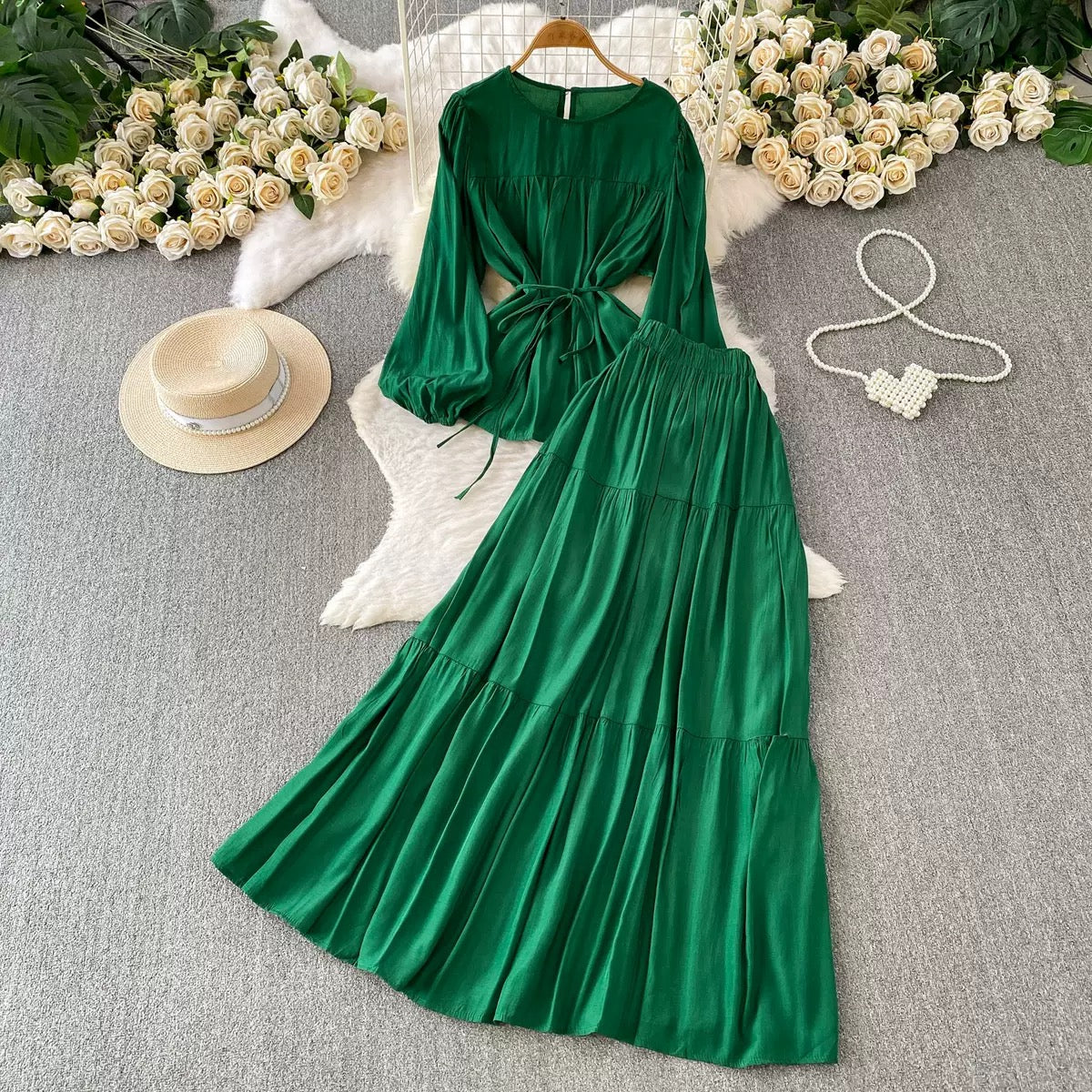 French-style chic casual two-piece set: a loose, round-neck pullover top with a waist-cinching tie detail (designed for a slimming effect) paired with a high-waisted long skirt—suitable for work or daily wear.👉 (30% advance) vibrant vogue